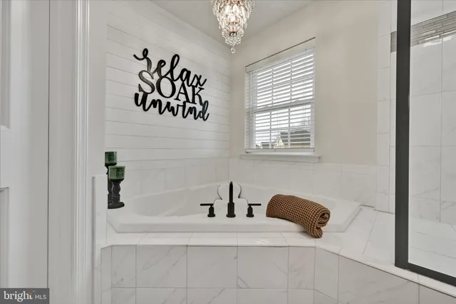 a bedroom with a bed and a potted plant