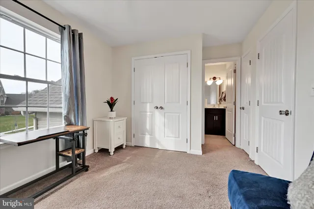 a large white house with a big yard and large trees