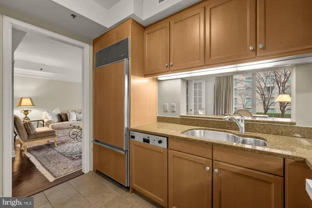 a kitchen with stainless steel appliances granite countertop a refrigerator and a sink
