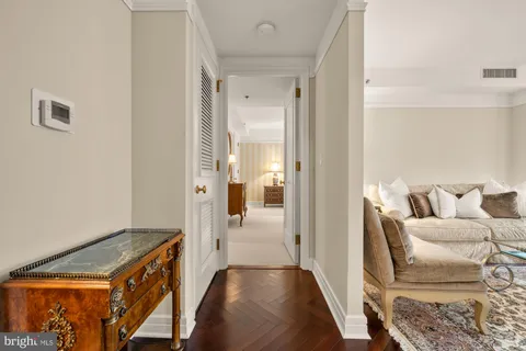 a view of a hallway with furniture and front door