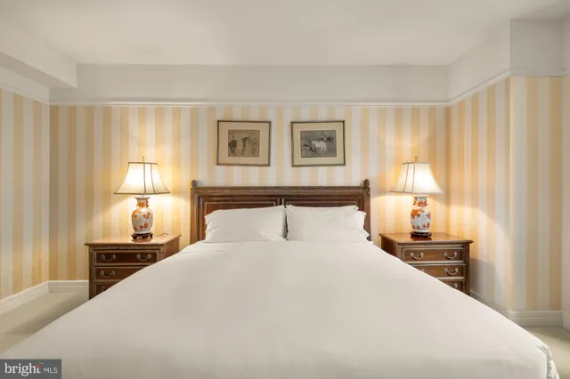 a bedroom with a bed and a lamp