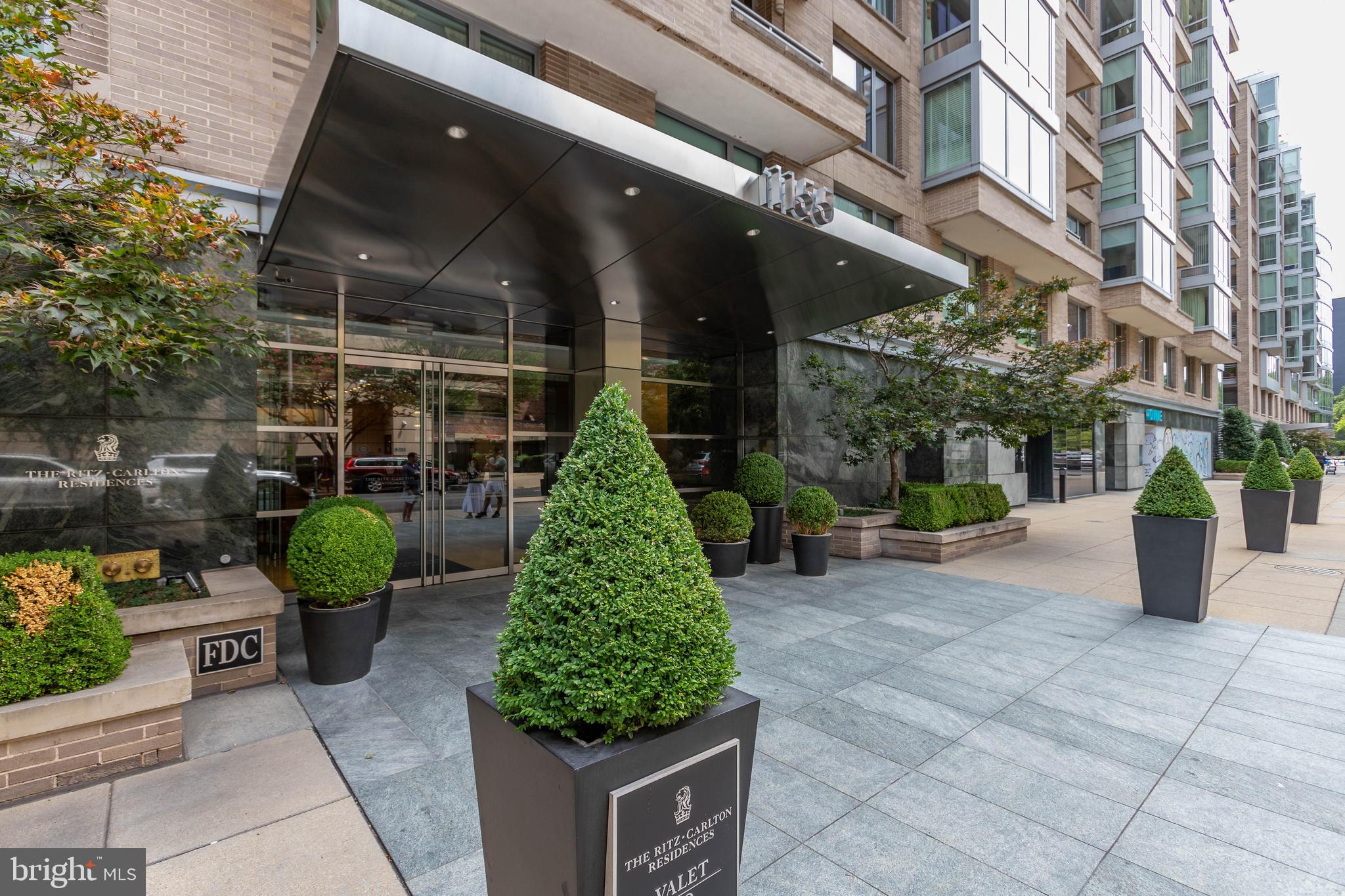 1155 23rd Street Northwest, Unit 6H Washington, DC 20037 - Photo 2 of 27 a front view of a building with garden