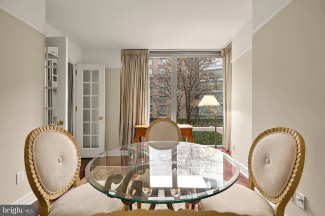 a dining room with wooden floor and a table