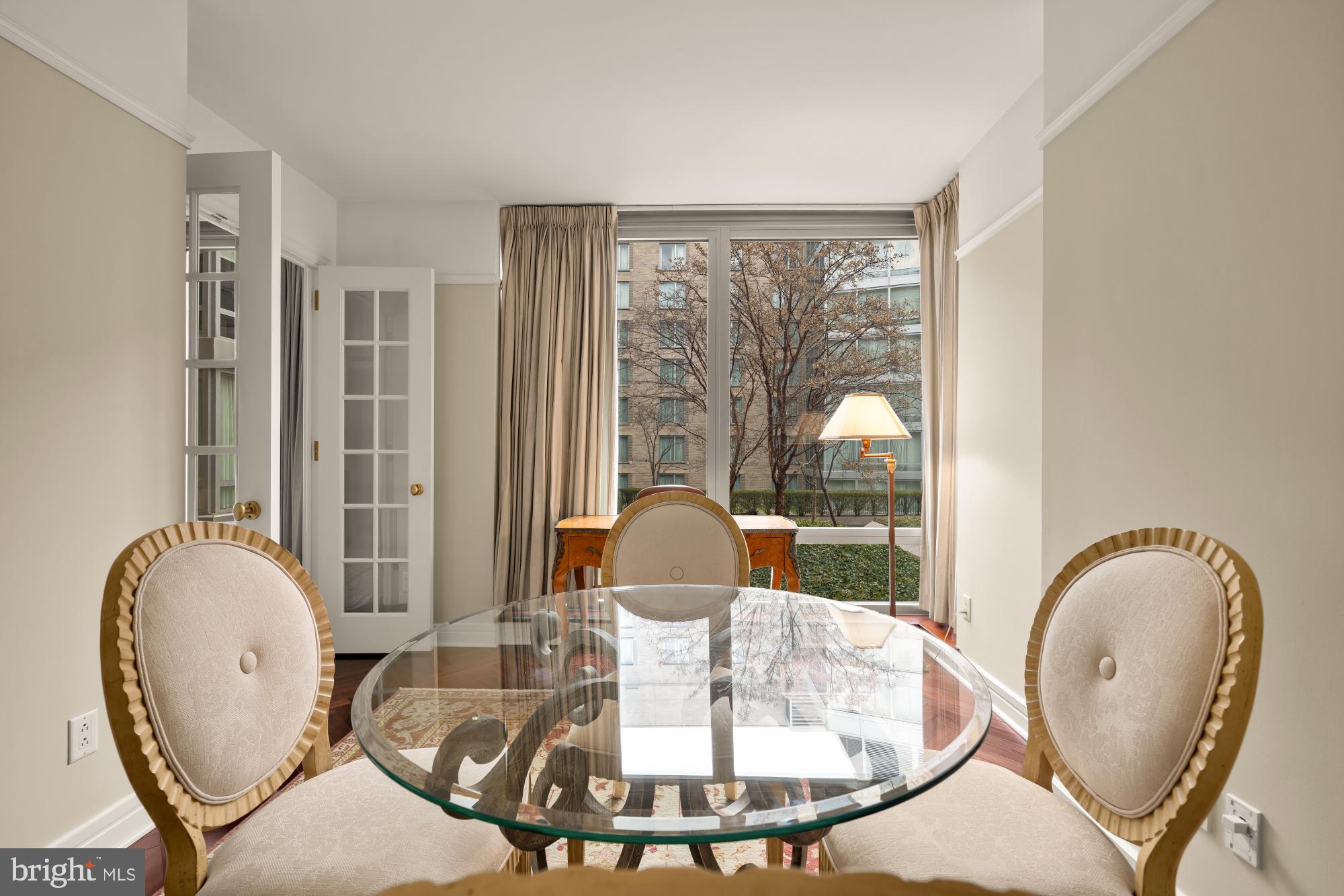1155 23rd Street Northwest, Unit 6H Washington, DC 20037 - Photo 10 of 27 a dining room with wooden floor and a table