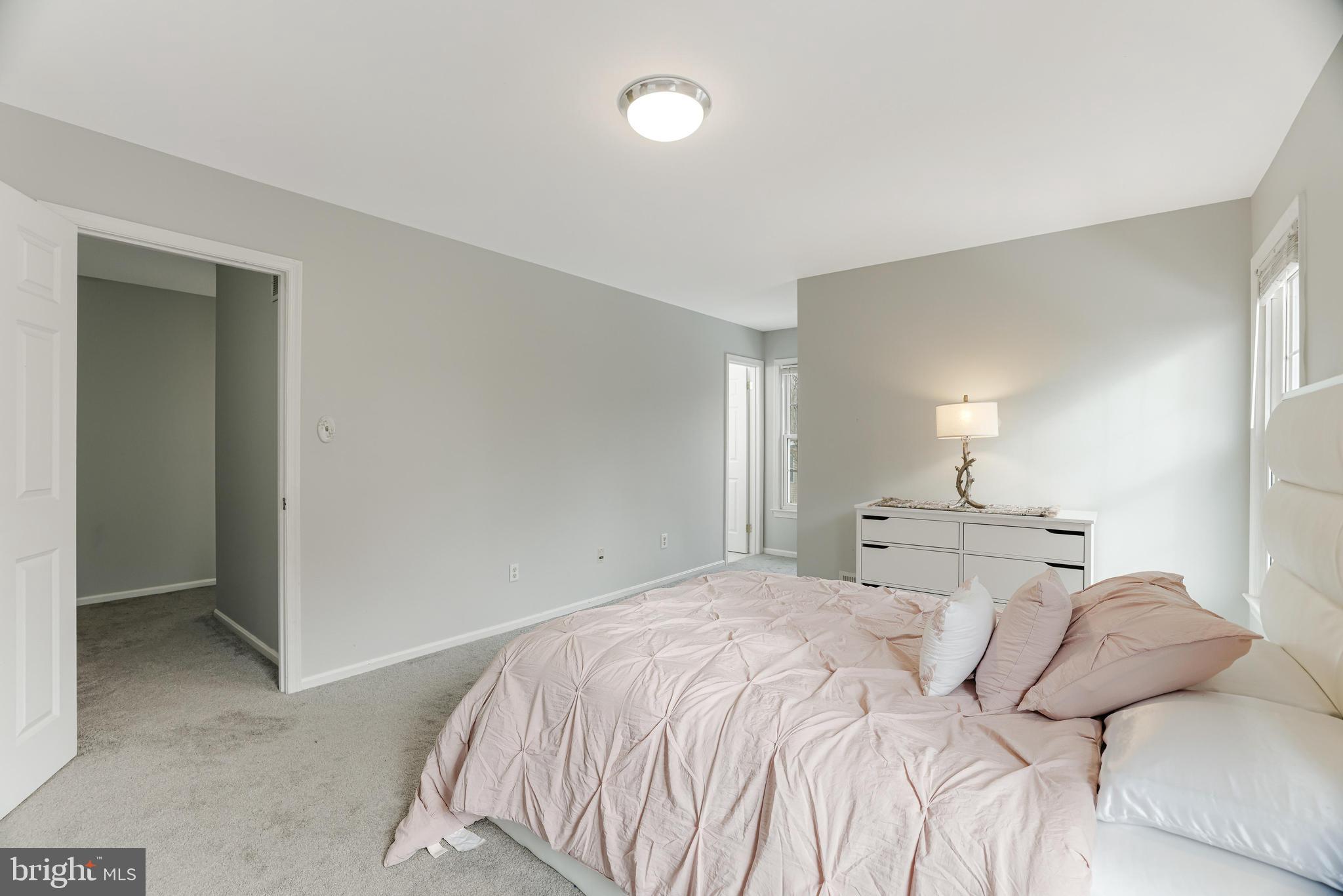 8813 Winding Hollow Way Springfield, VA 22152 - Photo 12 of 29 a bedroom with a bed and a lamp