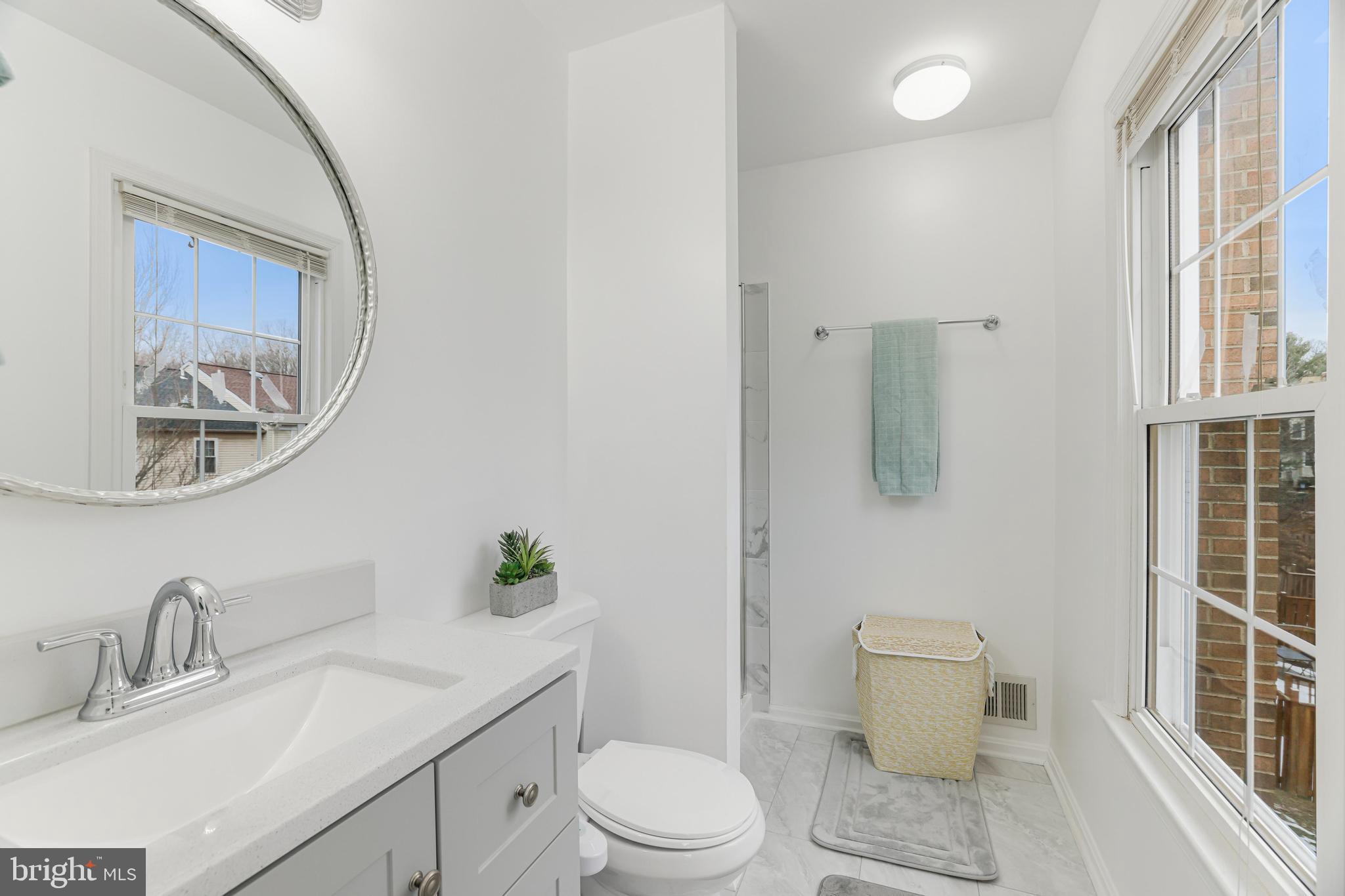8813 Winding Hollow Way Springfield, VA 22152 - Photo 13 of 29 a white toilet sitting next to a bathroom sink