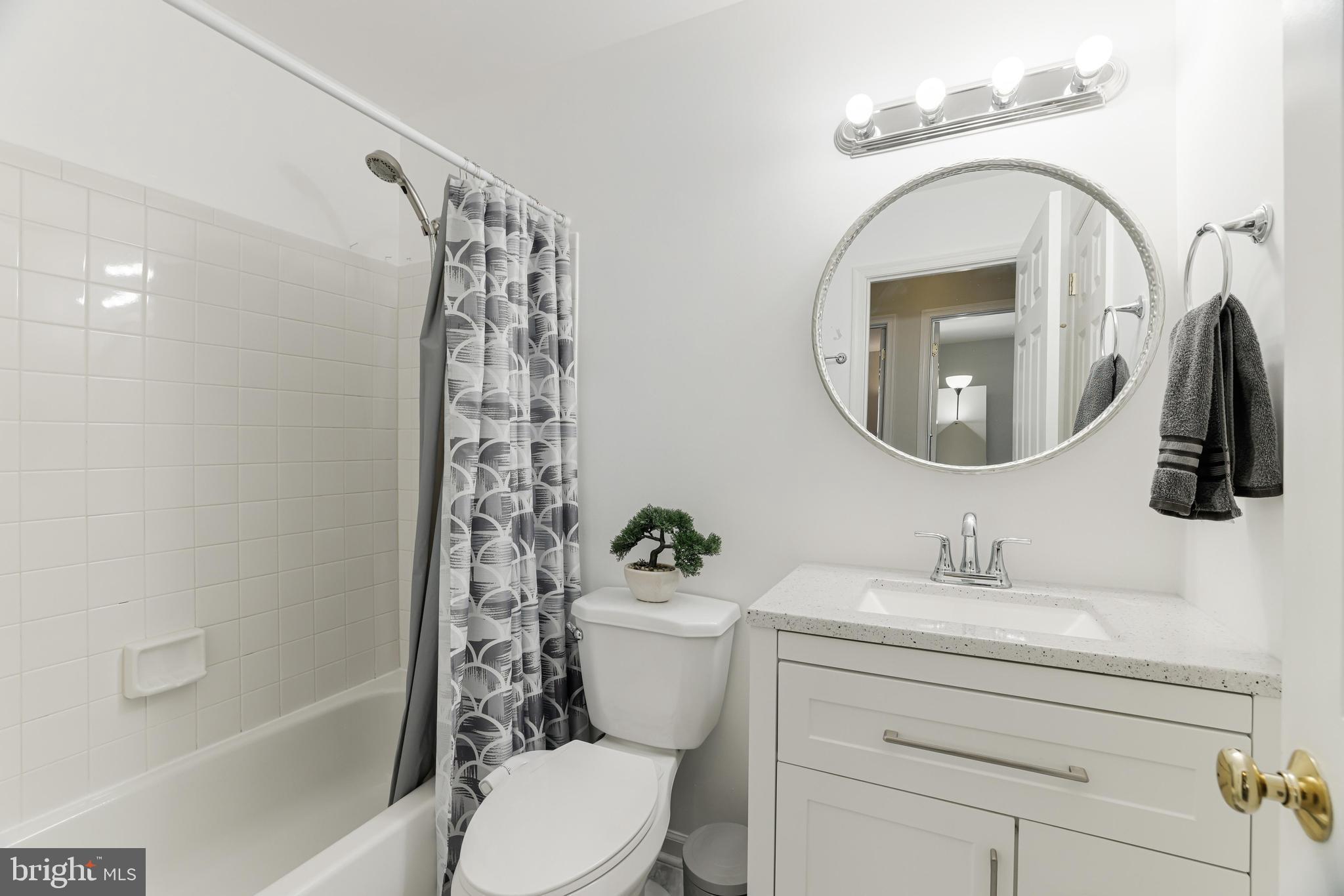 8813 Winding Hollow Way Springfield, VA 22152 - Photo 15 of 29 a bathroom with a sink a toilet and a mirror