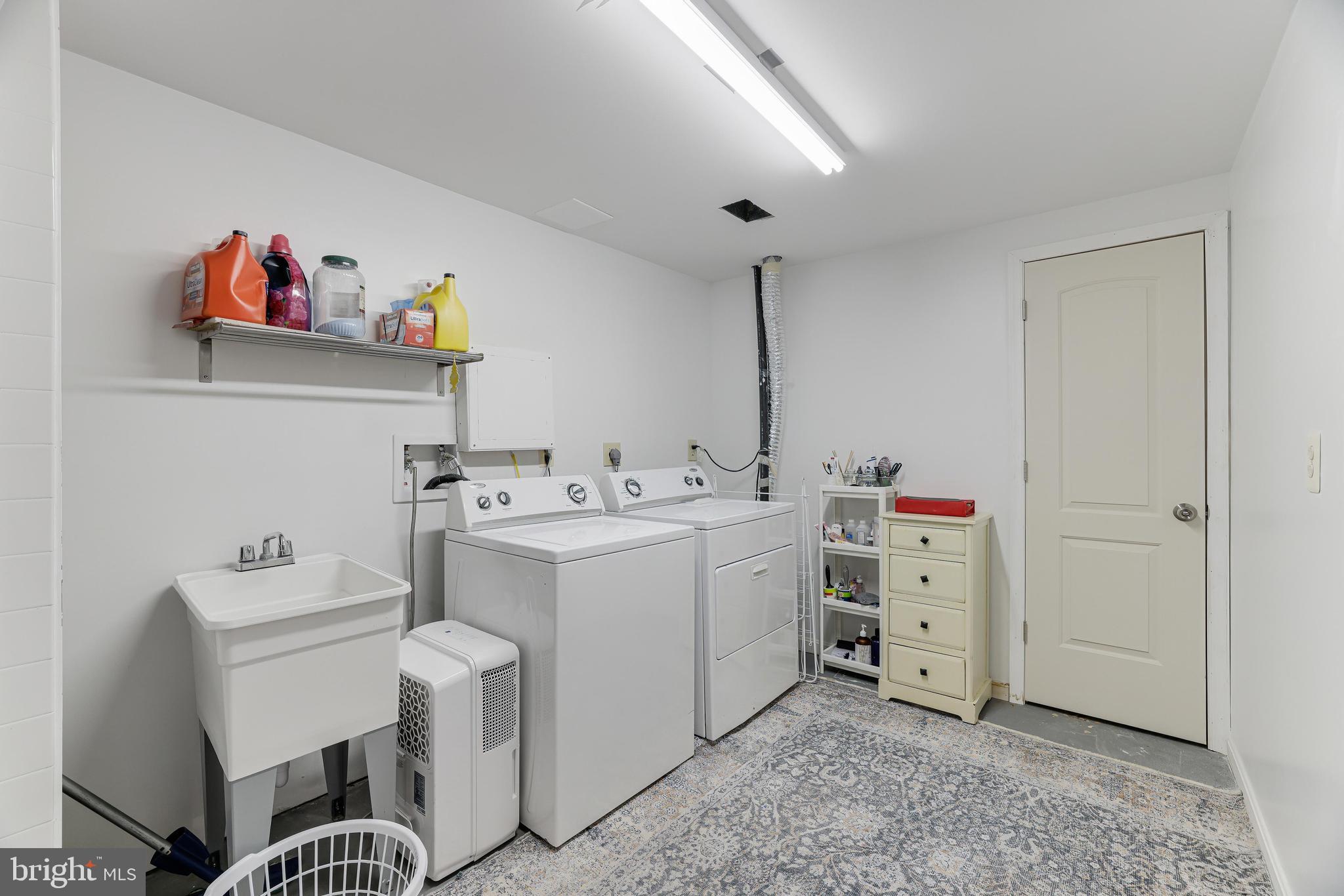 8813 Winding Hollow Way Springfield, VA 22152 - Photo 19 of 29 a utility room with cabinets dryer and washer
