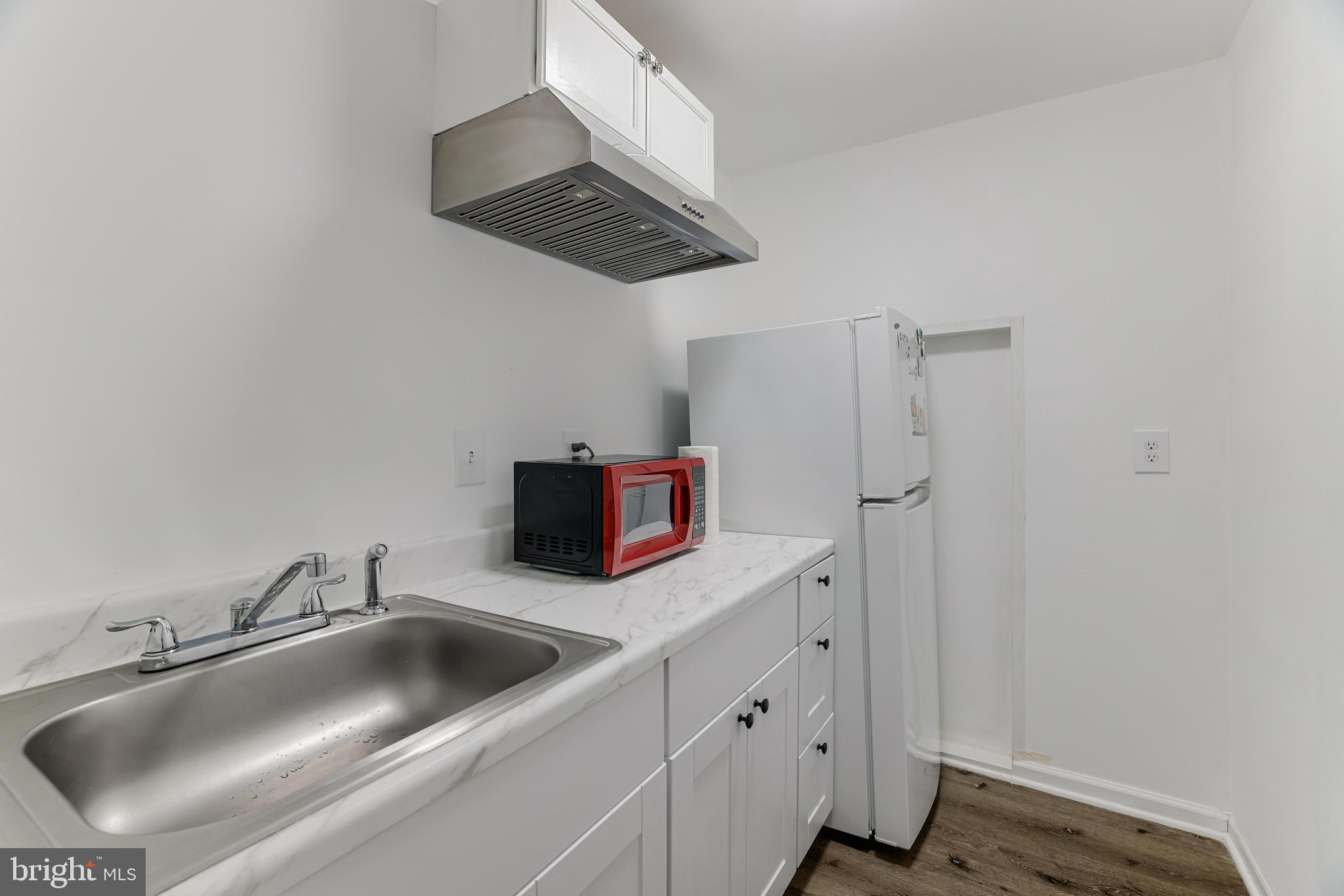 8813 Winding Hollow Way Springfield, VA 22152 - Photo 24 of 29 a kitchen with stainless steel appliances a sink and a refrigerator