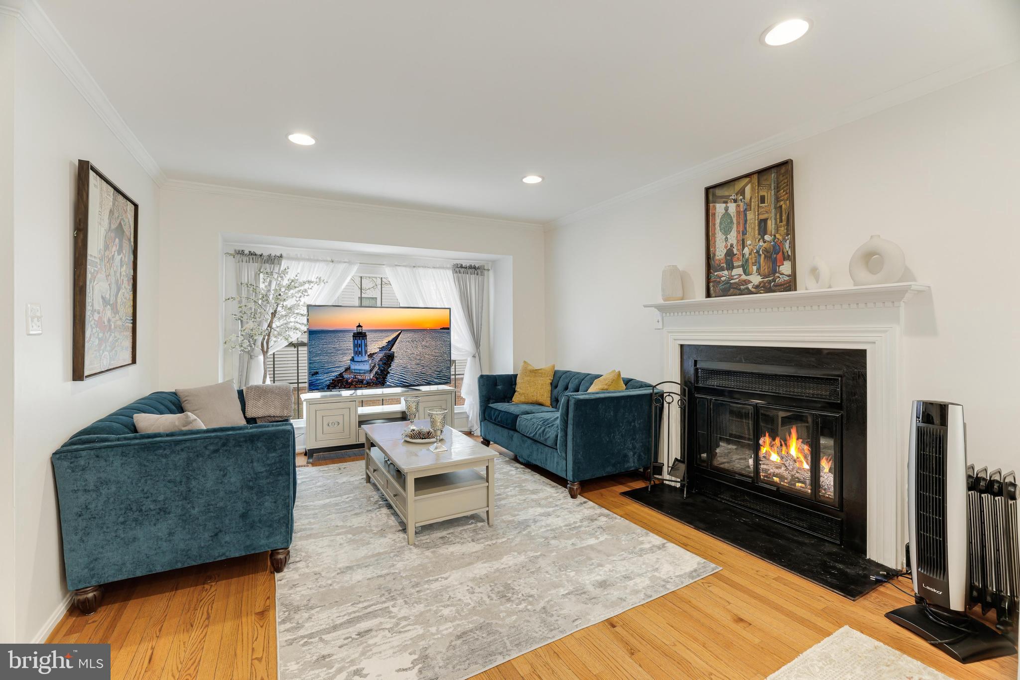 8813 Winding Hollow Way Springfield, VA 22152 - Photo 6 of 29 a living room with furniture and a fireplace