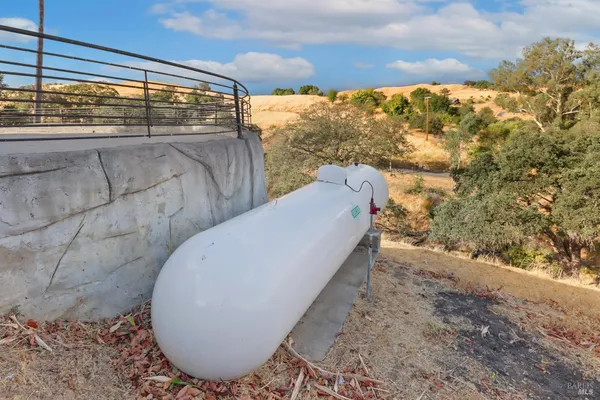 a kitchen with stainless steel appliances kitchen island granite countertop a stove a sink a dining table and chairs