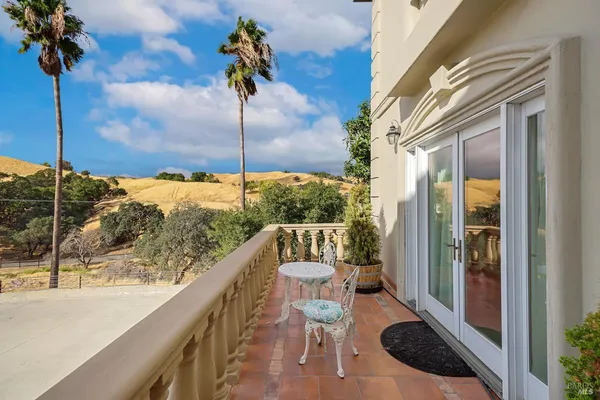 a spacious bathroom with a granite countertop sink and a mirror