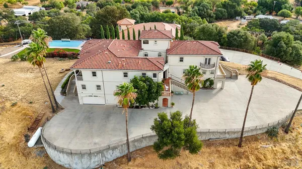 an aerial view of a house with garden space and lake view