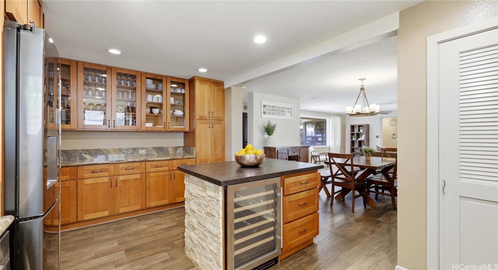 91-779 Fort Weaver Road Ewa Beach, HI 96706 - Photo 11 of 25 Functional kitchen layout highlighting extensive cabinetry, a built-in wine refrigerator, and seamless dining access.