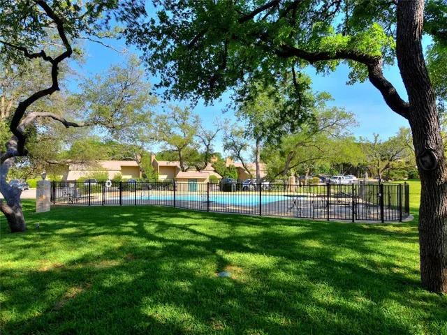 a view of a park with large trees