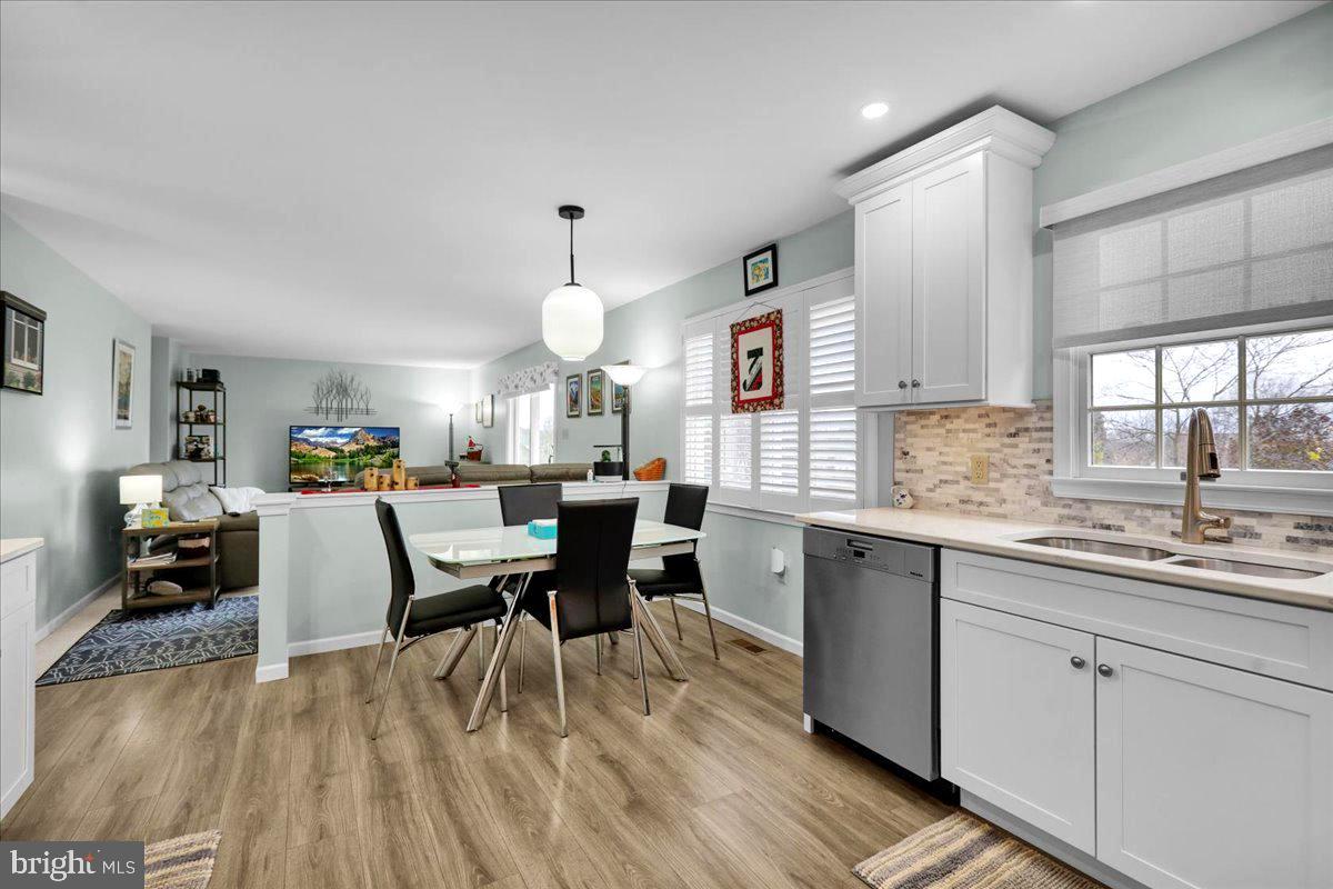 1102 Pepper Ridge Drive Reading, PA 19606 - Photo 8 of 33 a open kitchen with stainless steel appliances granite countertop a stove top oven a sink dishwasher white cabinets and couches with wooden floor