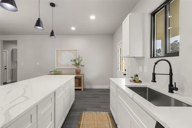 a kitchen with a sink stove and cabinets