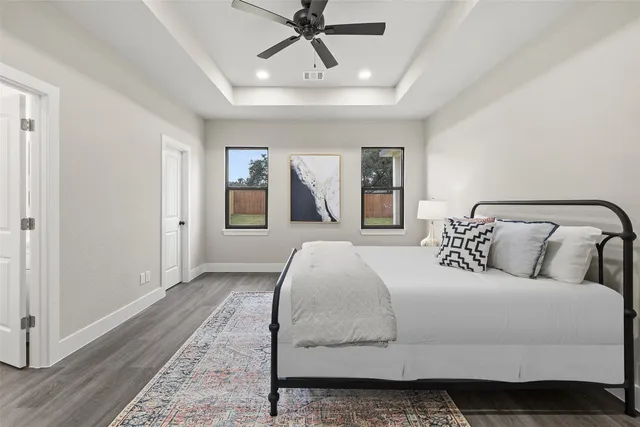a bedroom with a large bed and a chandelier
