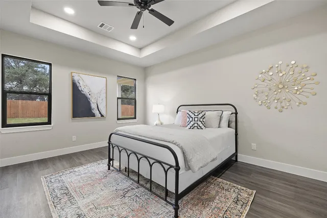 a bedroom with a large bed and a chandelier