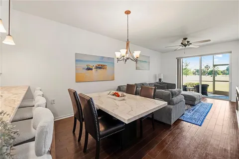 a living room with furniture a chandelier and a table