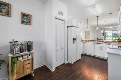 a kitchen with cabinets and wooden floor