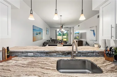 a kitchen with a sink and a granite counter tops