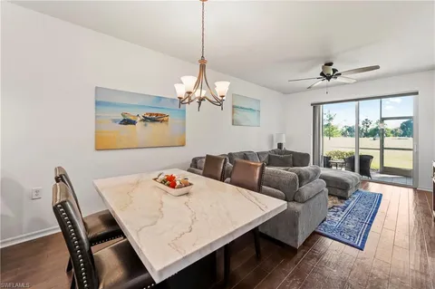 a living room with furniture a table and a chandelier