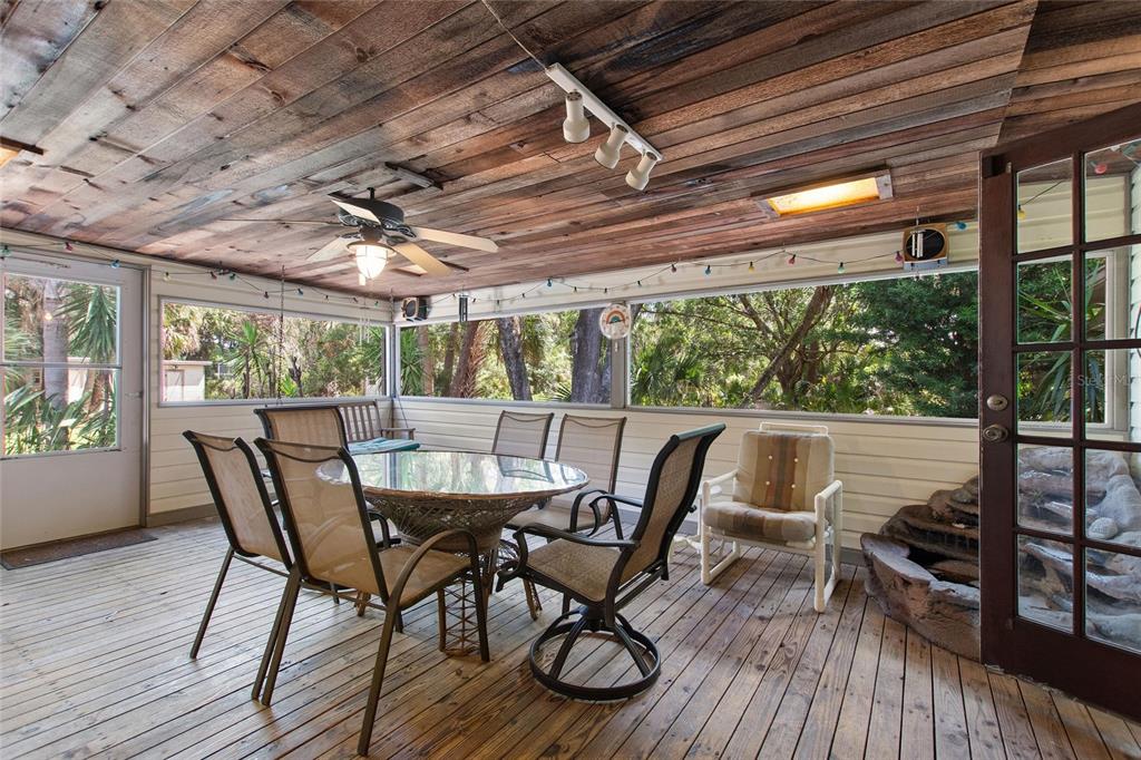 3641 Turtle Mound Road Melbourne, FL 32934 - Photo 15 of 77 a view of a patio with table and chairs and wooden floor