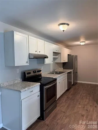 a kitchen with stainless steel appliances granite countertop a stove and a sink