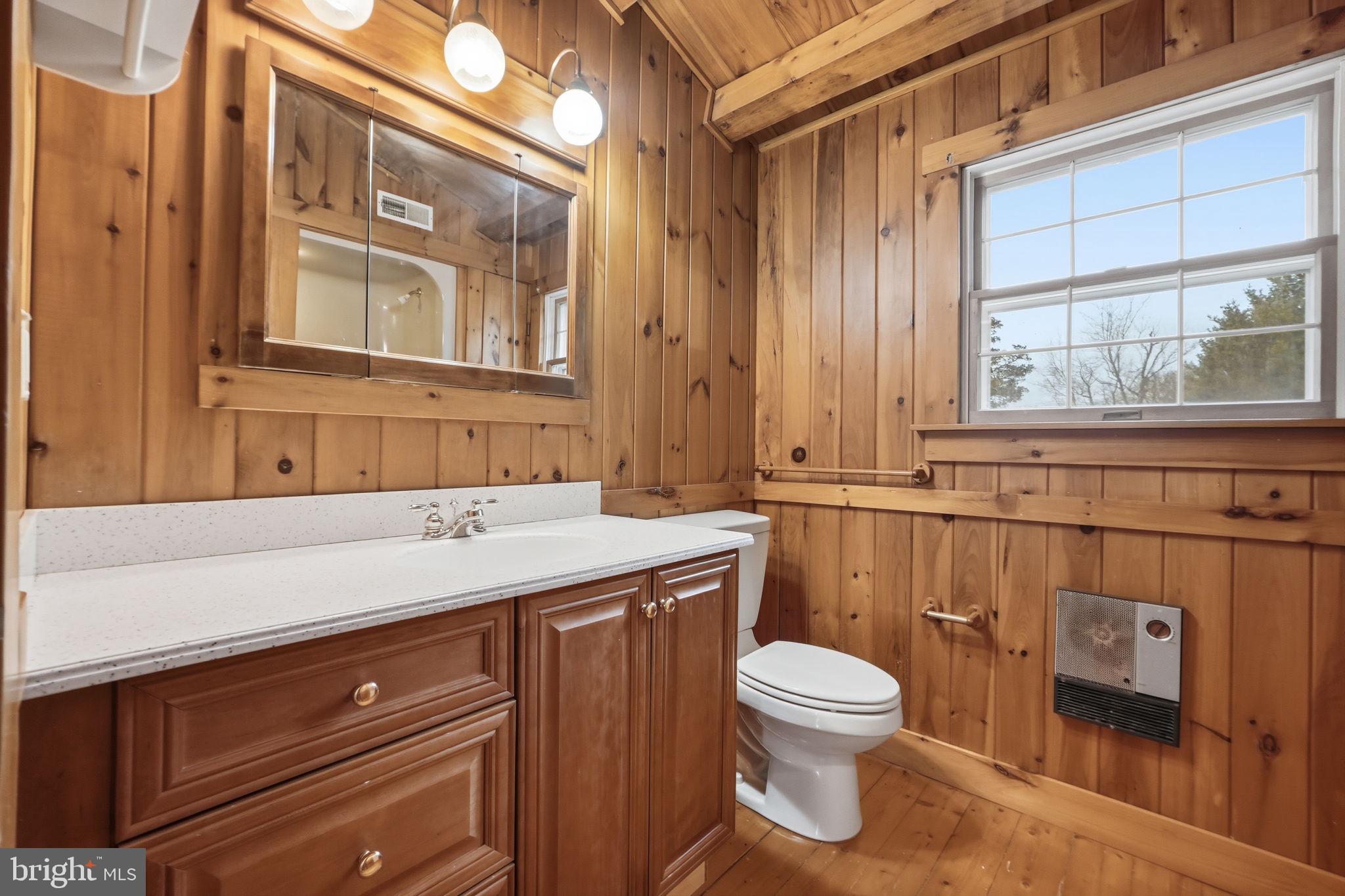 21142 Westerly Road Poolesville, MD 20837 - Photo 26 of 76 a bathroom with a granite countertop toilet sink and mirror