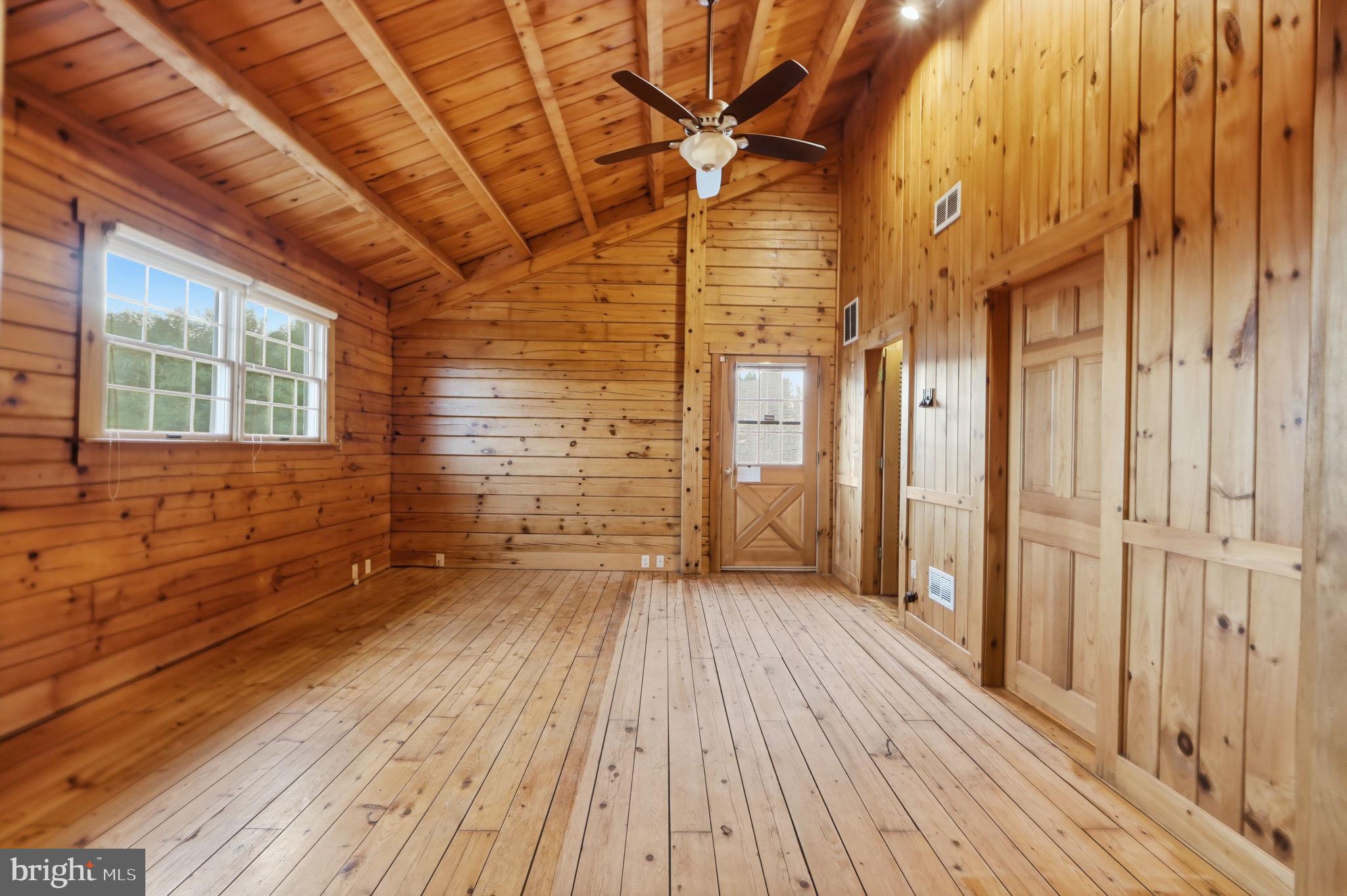 21142 Westerly Road Poolesville, MD 20837 - Photo 31 of 76 a view of an empty room with wooden floor and a window