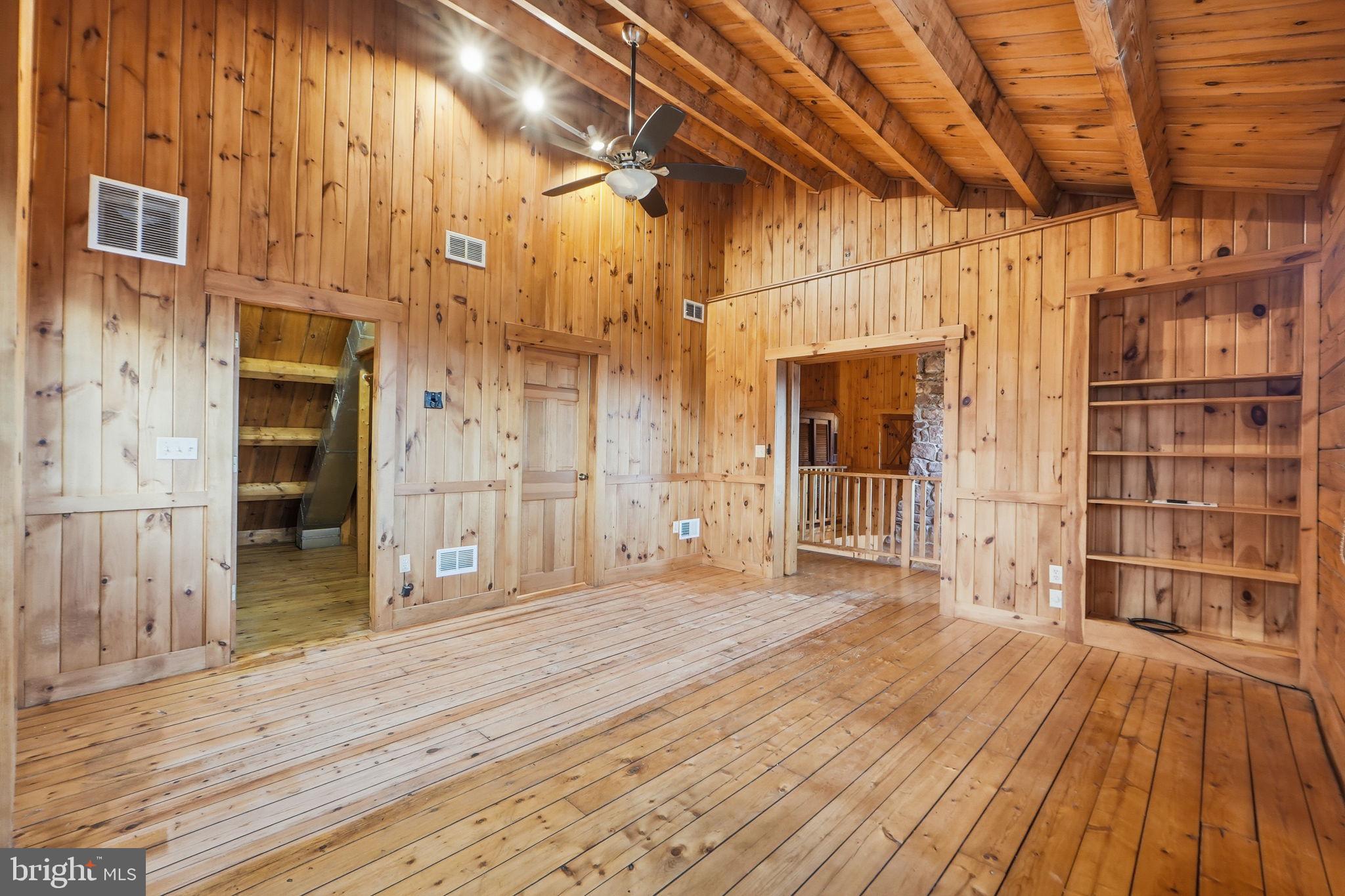 21142 Westerly Road Poolesville, MD 20837 - Photo 32 of 76 a view of an empty room with wooden floor and a window