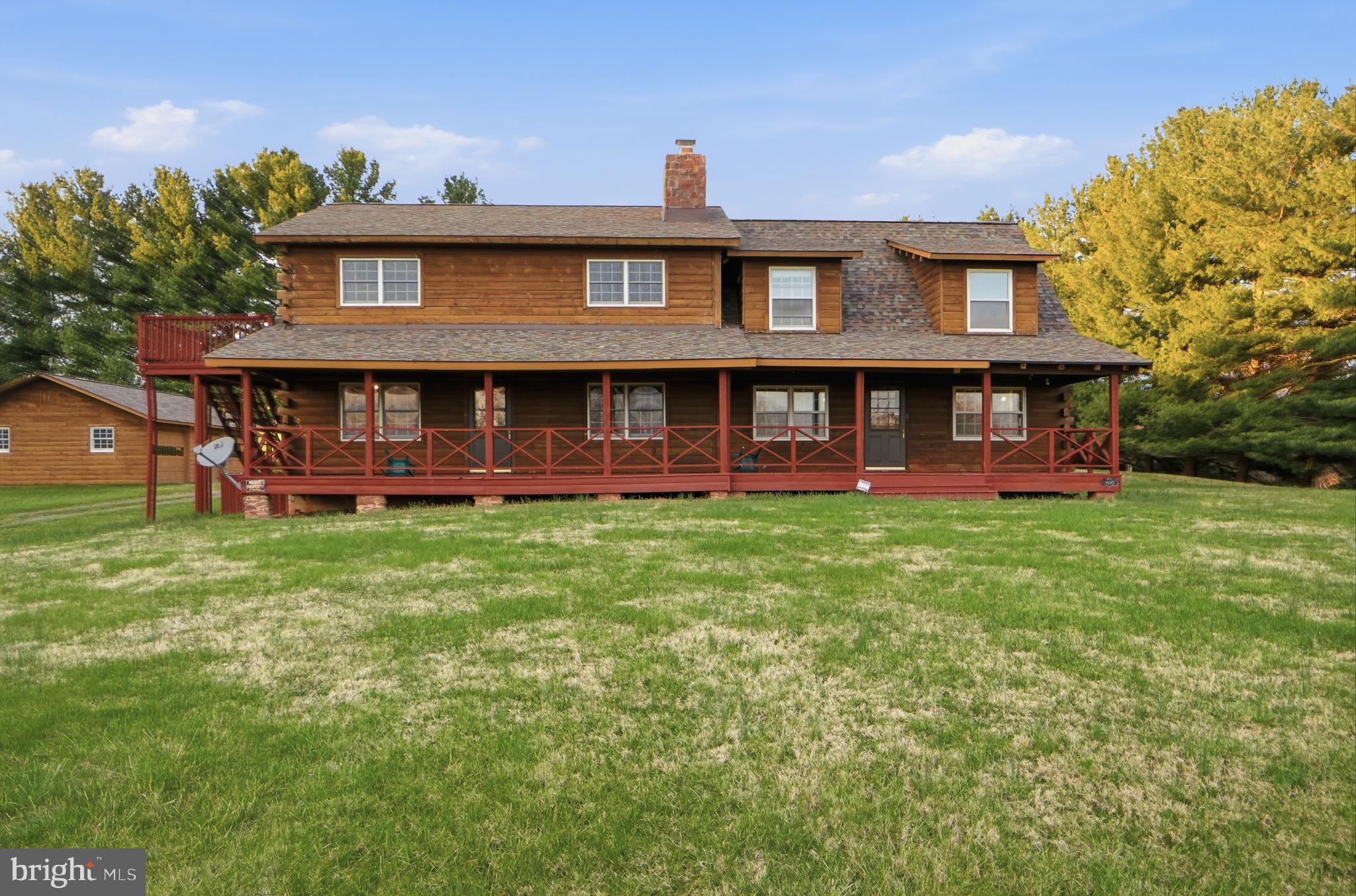 21142 Westerly Road Poolesville, MD 20837 - Photo 40 of 76 a front view of a house with a yard table and chairs