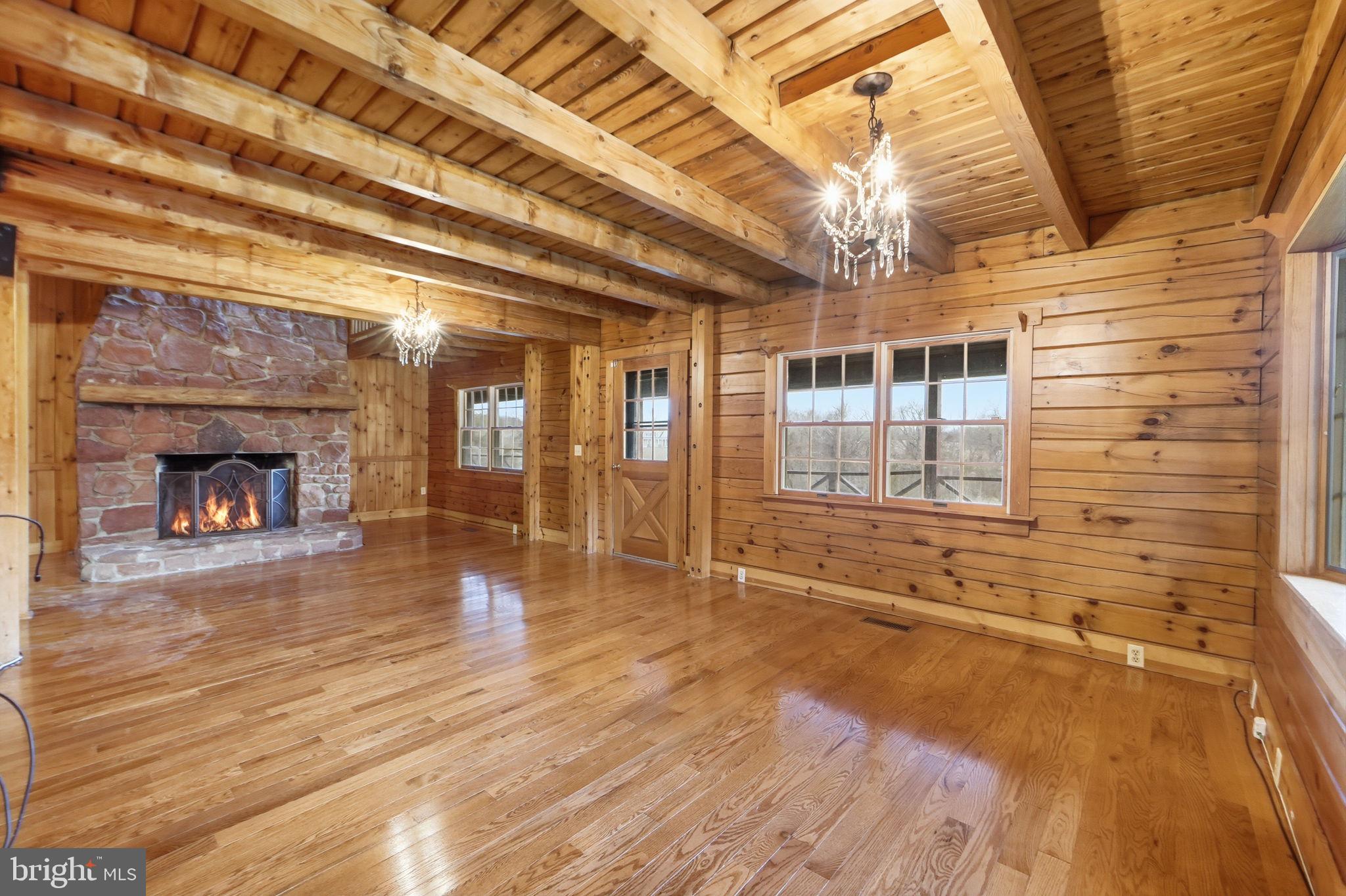 21142 Westerly Road Poolesville, MD 20837 - Photo 44 of 76 a view of empty room with wooden floor and fireplace