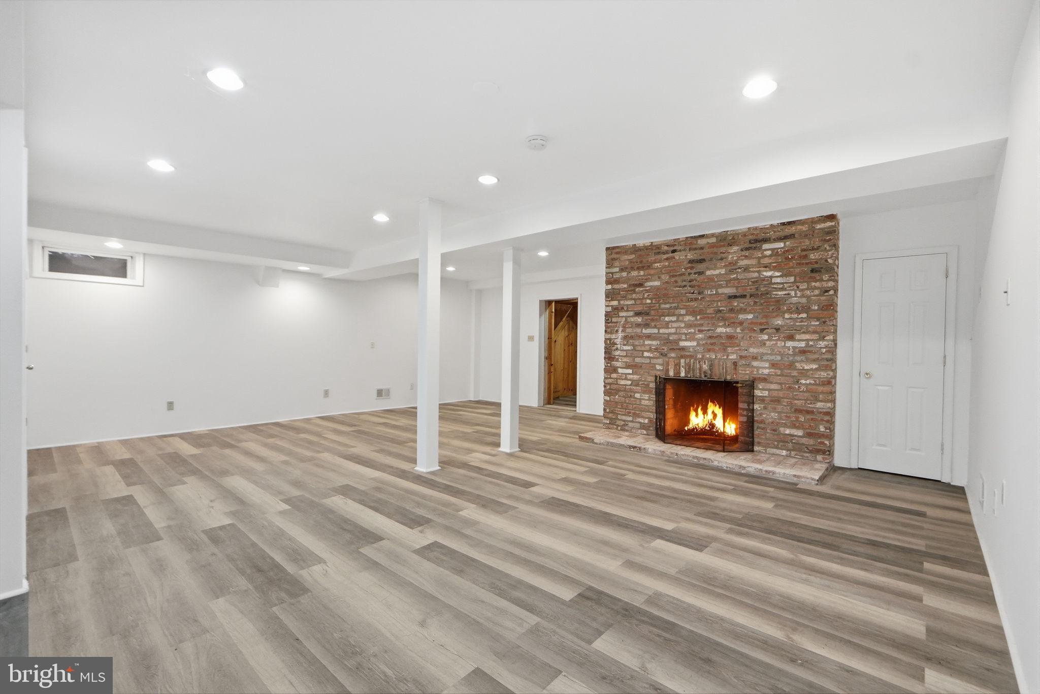 21142 Westerly Road Poolesville, MD 20837 - Photo 45 of 76 a view of an empty room with a fireplace
