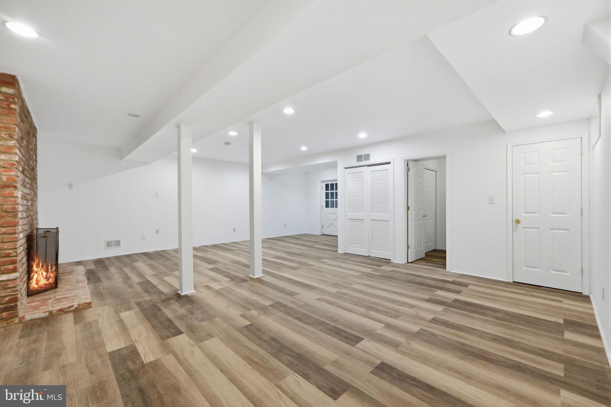 21142 Westerly Road Poolesville, MD 20837 - Photo 47 of 76 a view of an empty room with wooden floor