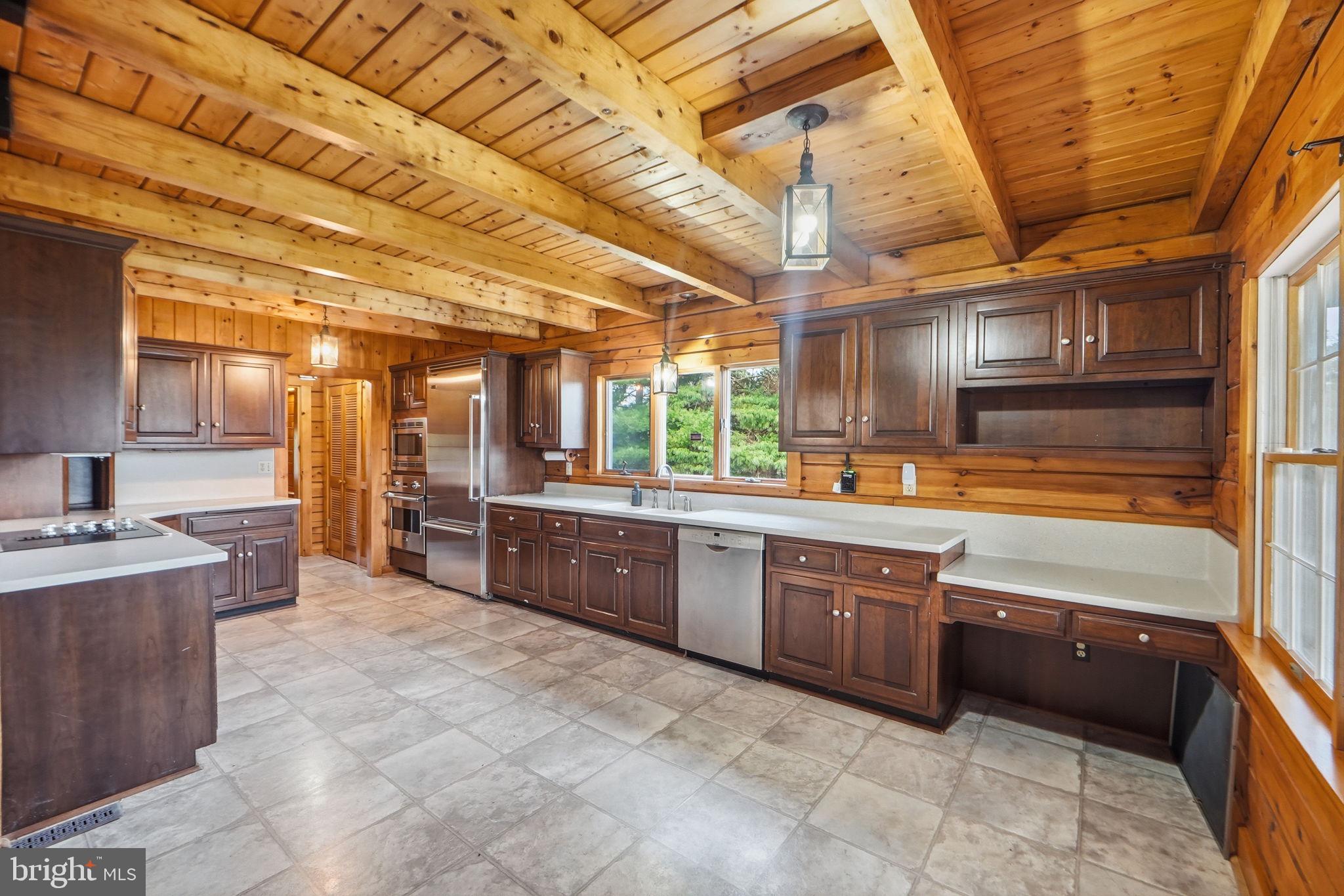 21142 Westerly Road Poolesville, MD 20837 - Photo 6 of 76 a large kitchen with stainless steel appliances and wooden cabinets