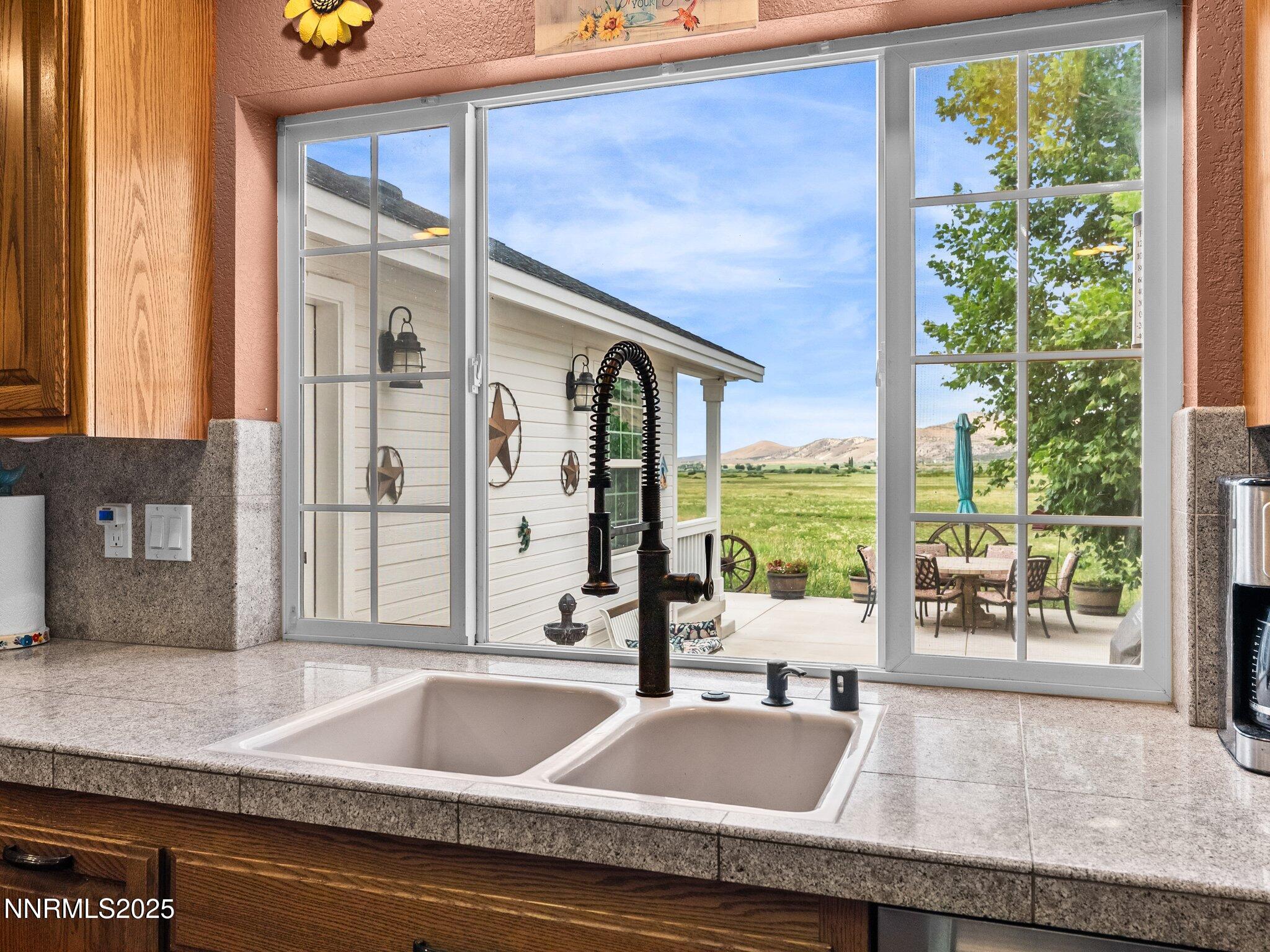 801 Larson Lane Coleville, CA 96107 - Photo 8 of 37 a kitchen with granite countertop a sink and a large window