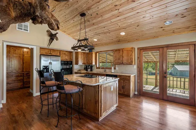 a view of backyard with swimming pool and patio