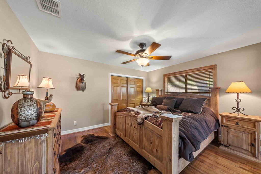 161 East Flach Road Comfort, TX 78013 - Photo 39 of 91 a bed room with a bed and a chandelier