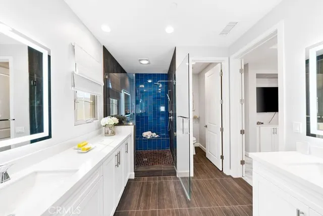 a bathroom with a tub a sink and a large mirror