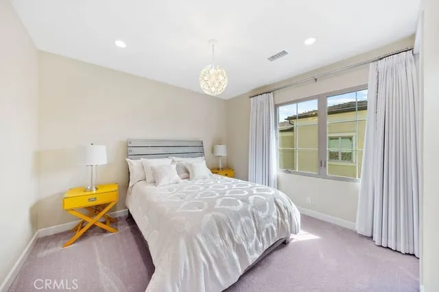 a bedroom with a bed a table and a window