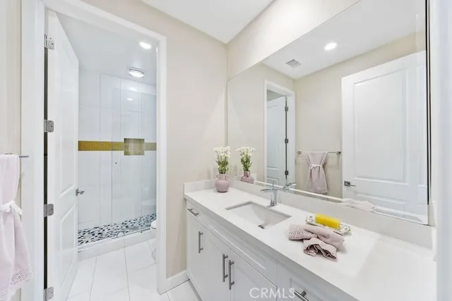 a bathroom with a tub sink and mirror