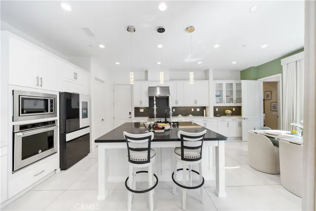 a large kitchen with a table and chairs