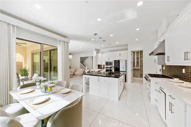 a kitchen with stainless steel appliances kitchen island granite countertop a sink and cabinets