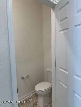 a white toilet sitting next to a shower