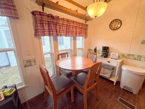 a view of a dining room with furniture window and wooden floor