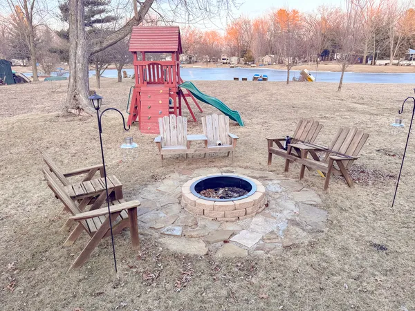 a view of a backyard with a patio and fire pit