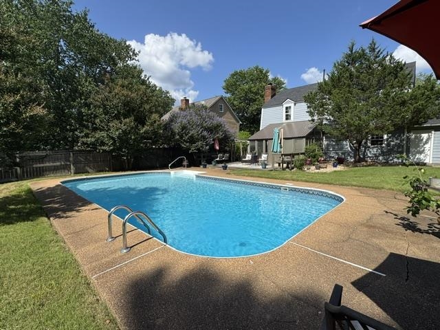 1897 Corbin Road Germantown, TN 38139 - Photo 9 of 22 In-ground swimming pool with integrated entry steps and a surrounding aggregate concrete deck