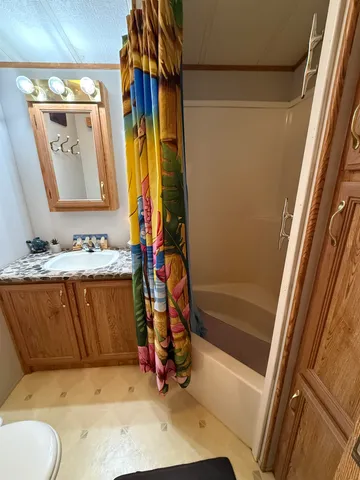 a bathroom with a tub sink and mirror